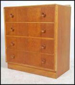 A 1970's Meredew natural oak retro chest of drawers. The upright bank of drawers with turned knob