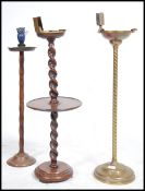 A collection of 3 vintage early 20th century ashtray stands to include a brass twist stand, an oak