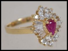A stunning ladies 14ct yellow gold and ruby with diamond cluster ring. The heart shape ruby being
