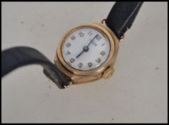 A 9ct gold / 375 Tudor ( rolex ) ladies dress / cocktail watch being set to a black leather strap.