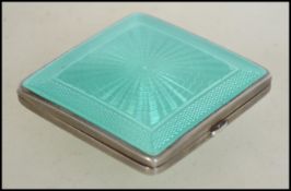 A silver 1930's Art Deco hallmarked enamel engine turned ladies compact by Henry Matthews ? of