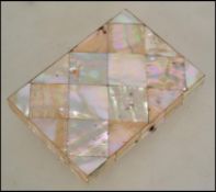 A Victorian mother of pearl shell card case, set with panels of mother of pearl having a central