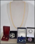 A group of jewellery to include a faux pearl necklace with silver tone metal clasp, a pale blue