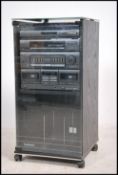 A 1990's Sony stacking music system housed within a Technics music cabinet.