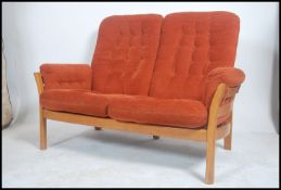 An Ercol Renaissance two seat sofa settee in golden dawn having stunning shaped frame with slat back