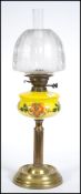 A Victorian oil lamp having a stunning acid etched glass shade set over a yellow glass handpainted