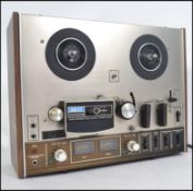 An original vintage Akai 4000DS model reel to reel tape recorder player set within original wooden