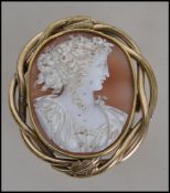 A late 19th century yellow metal mounted cameo brooch of Flora, mounted in a pinch-beck surround.