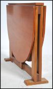 A 1970's thin Teak wood Danish inspired drop leaf dining table having large full length leaves