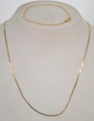 A 9ct gold flat linked fine ladies necklace together with a matching flat link 9ct bracelet. Total