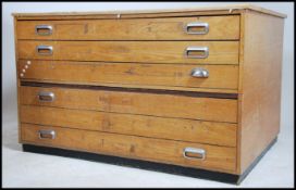 A mid century oak architects plan chest of drawers. The large body with an upright bank of drawers
