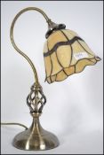 A contemporary Brass and coloured leaded glass Tiffany style desk lamp with pendant shade on