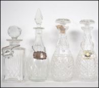 A pair of cut glass decanters together with 2 other cut glass decanters, one being Edinburgh