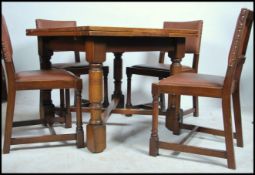 A 1930's Art Deco oak draw leaf dining table raised on block and turned supports together with a set