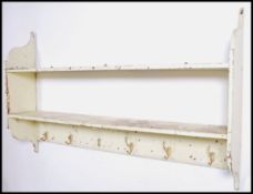 An early 20th century painted shabby chic open farmhouse kitchen shelving. Having a series of open