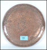 A late Victorian Arts & Crafts hand beaten copper