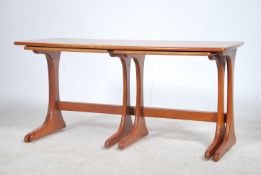 A 1970's retro teak wood nest of tables having large rectangular coffee table top with two smaller