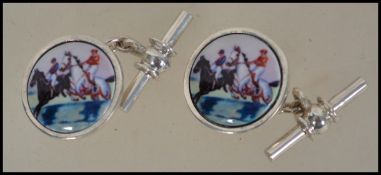 A pair of gentleman's silver and enamel set cuff links depicting horse and jockey - horse racing
