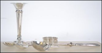 A collection of silver hallmarked items to include a candle stick, Birmingham 1973 by AT Cannon,