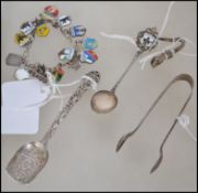 An interesting mixed silver lot to include a stamped 925 charm bracelet with various place name