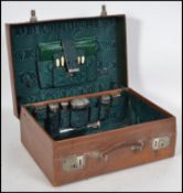 A silver hallmarked leather vanity suitcase. The green leather case with monogram top. Inside a