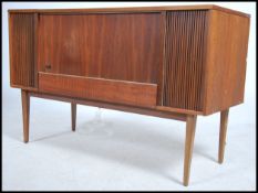 A retro 1970's teak wood cabinet radiogram by Stella, with a lift up lid opening to reveal a
