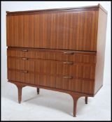 A 1970's retro teak wood - afromosia sideboard bureau having a fall front top with appointed
