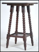 A 19th century carved mahogany gypsy side occasional table being raised on turned legs with carved