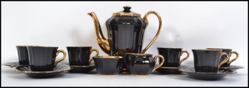 A vintage boxed 20th century coffee service by Wade, looks to be unused in the original box, black