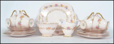 A stunning early 20th century Bone China Plant Tuscan tea service, consisting of six cups and