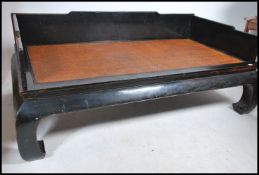 A Chinese elm daybed, with panelled three-quarter gallery back above a rectangular caned rattan