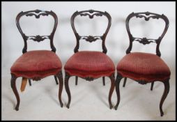 A set of 3 Victorian rosewood balloon back dining