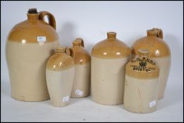 A group of six early 20th century glazed ceramic stone ware beer / cider flagons of mostly Bristol