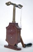 A 19th century German patented manual centrifuge test tube instrument with cast metal body in