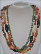 A green jade bead necklace having a barrel clasp along with a pale jade bangle bracelet and a