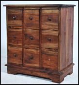 A 20th century hardwood chest of drawers, having an arrangement of nine index drawers raised on a