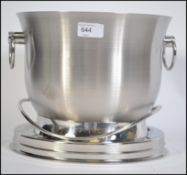 A contemporary 20th century stainless steel ice / Champagne bucket raised on a circular pedestal