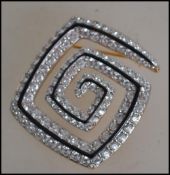 A contemporary Swarovski ladies crystal brooch in the ' greek key ' form having yellow metal back