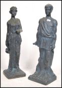A pair of  tall resin cast neo classical garden statues both being raised on plinth bases having