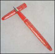 A mid century vintage Lady Sheaffer 10 Skripsert fountain pen with red body and gilded helix design.