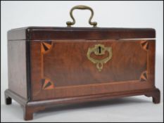 A 19th century Georgian mahogany and crossbanded inlaid tea caddy raised on bracket feet with