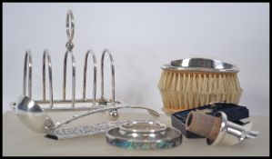 A collection of silver and silver plated items to include a continental silver comb holder, a pair