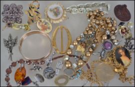 A collection of vintage and retro costume to include brooches, necklaces, earrings, cuff links etc.