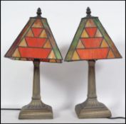 A pair of Art Deco style brass and coloured leaded glass Tiffany style desk lamp with angular
