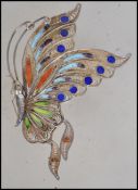 A silver filigree vintage butterfly brooch from the mid 20th century. The wings are decorated in