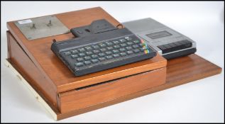 A vintage 1980's ZX Spectrum computer with keyboard and cassette player. Mounted to a scratch