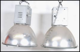 A pair of 20th century Industrial Hillclare factory pendant lights having half sphere polished