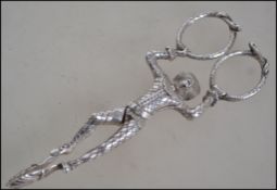 A pair of early Victorian cast novelty silver hallmarked sugar nips,/ tongs  in the form of a