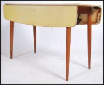 A vintage mid century large yellow formica and beech wood drop leaf dining - kitchenette table being