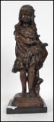 A bronze cast figure / sculpture of a young shoe-less girl holding a bouquet of flowers raised on
